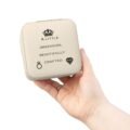 A person's hand holding a high-quality, cream-colored Premium Jewelry Storage Box featuring a black crown icon and the quote “A Little Obsession, Beautifully Crafted.”